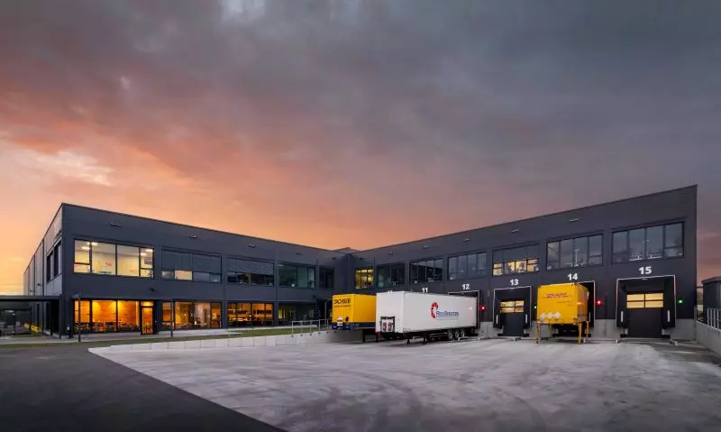 photo from the side of the heo campus with trucks in 2021