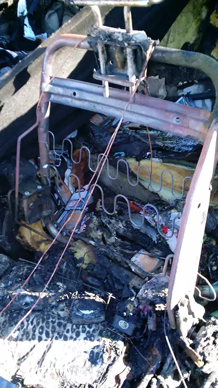 Photo of the burned car from inside with burned Twin Flip'n'Tray deck box