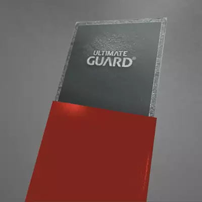 Photo inserting card bottom-first into outer sleeve of premium Katana Sleeve by Ultimate Guard