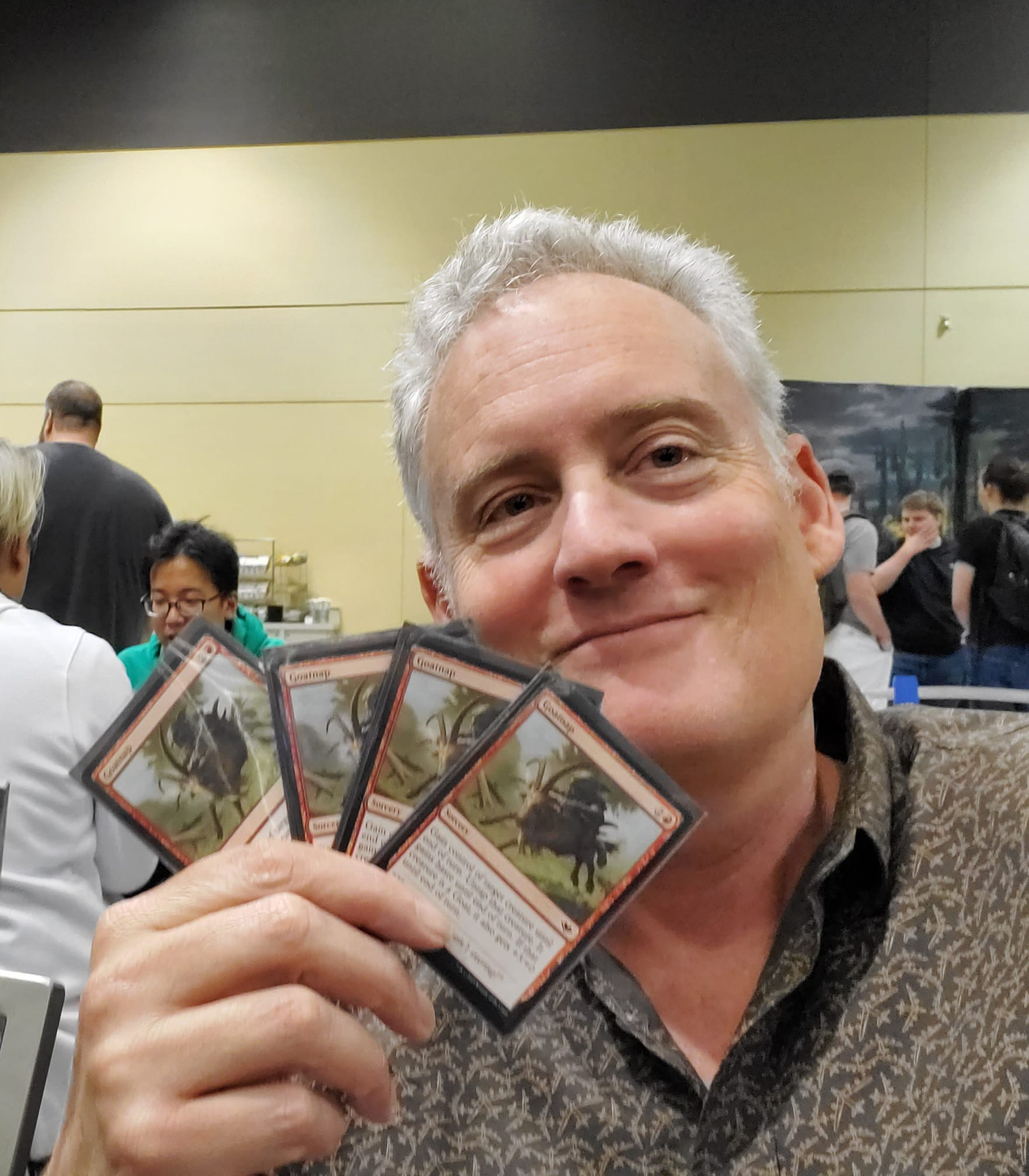 Photo of Rex Jakobovits holding up 4 cards from Magic: The Gathering