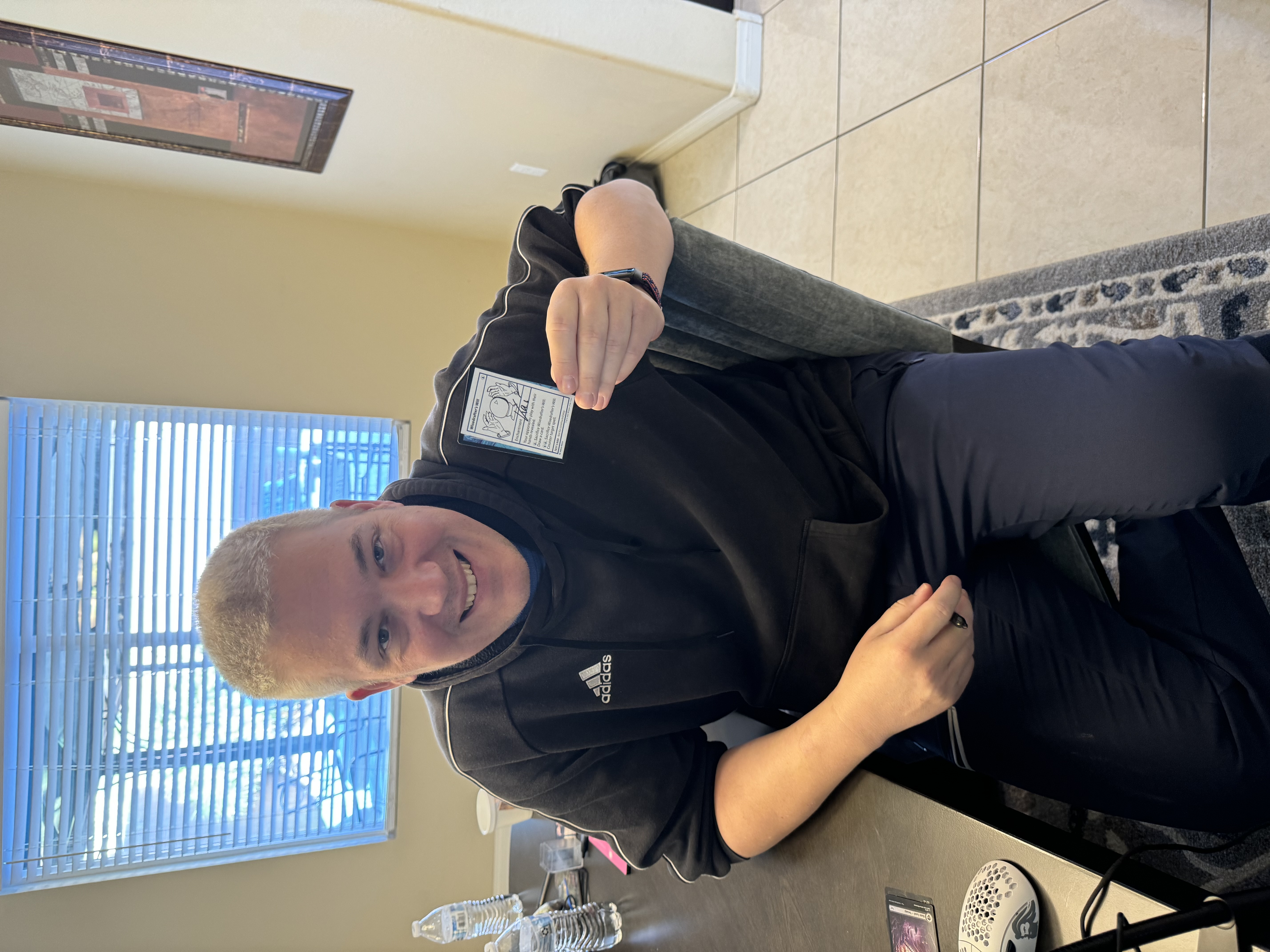 Kai Budde holding up signed Wisedrafters Will Card from Magic: The Gathering