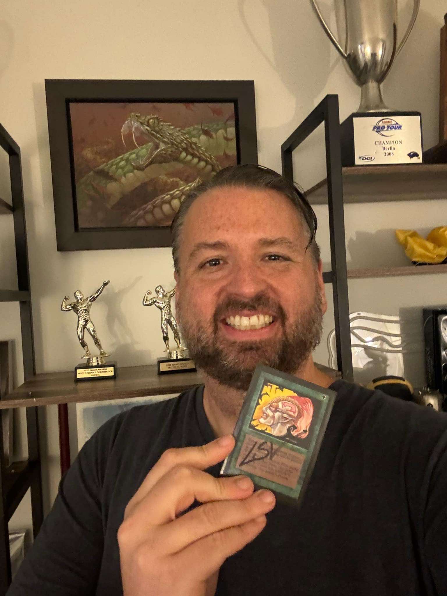 Luis Scott-Vargas holding signed Beta Llanowar Elves Card from Magic: The Gathering