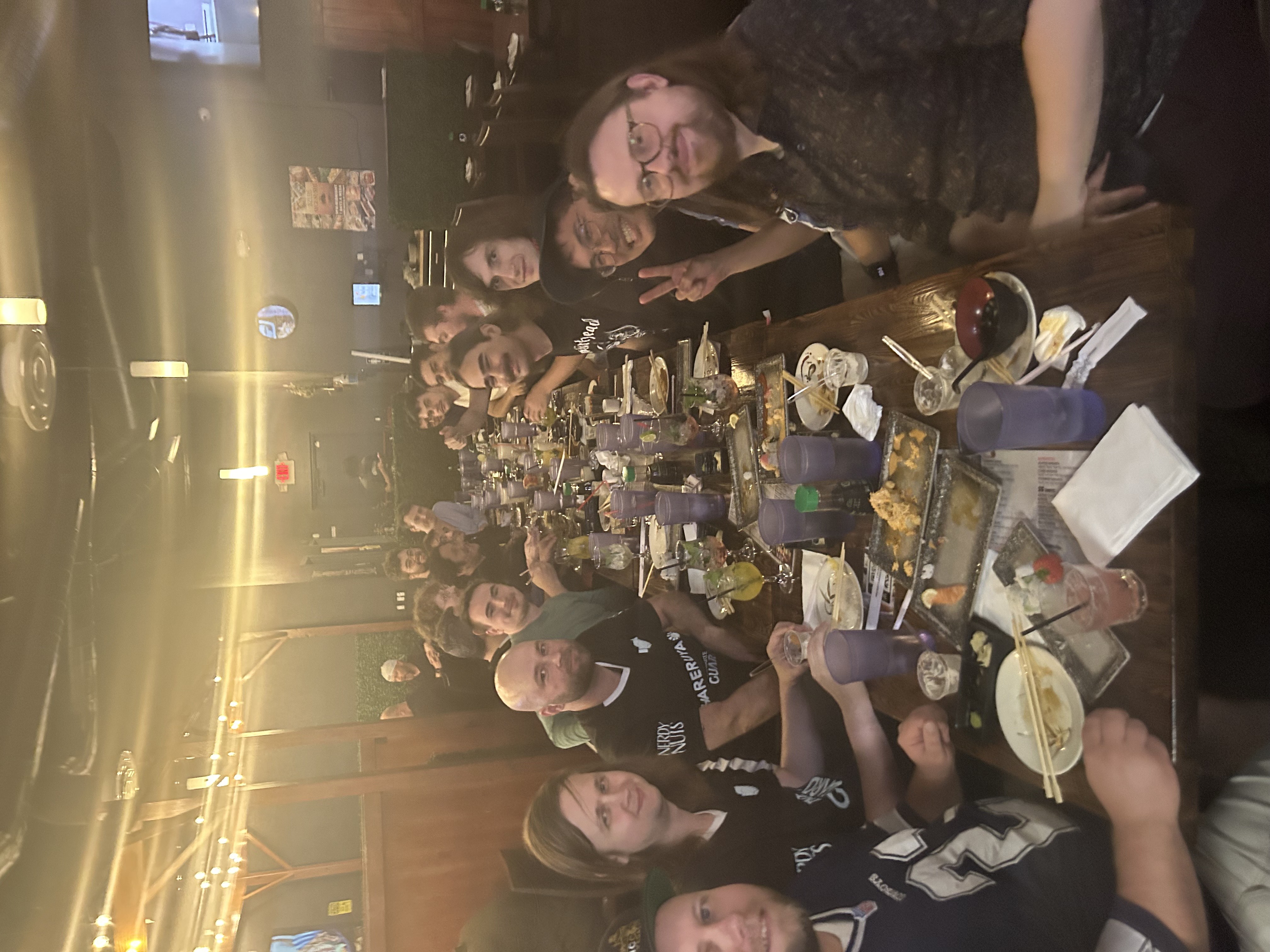 Team Handshake Ultimate Guard sitting by a dinner table